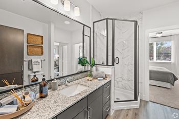 A bathroom with a sink, mirror, and shower. at Aurora Watson Branch, Mansfield, Texas